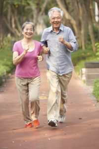 Senior Chinese Couple Jogging In Park