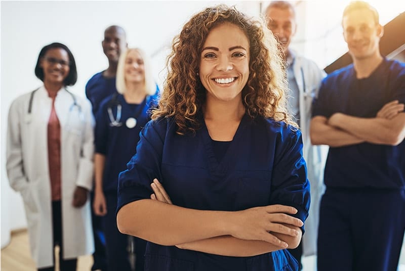 Standing medical professionals smiling at camera