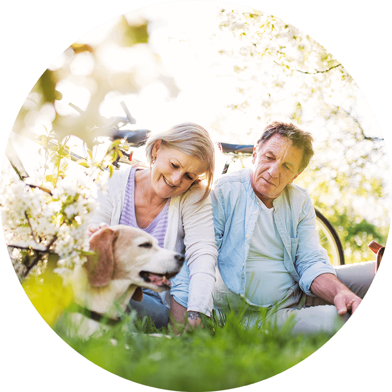 a man, woman, and dog outside