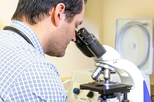 A man looking into a microscope