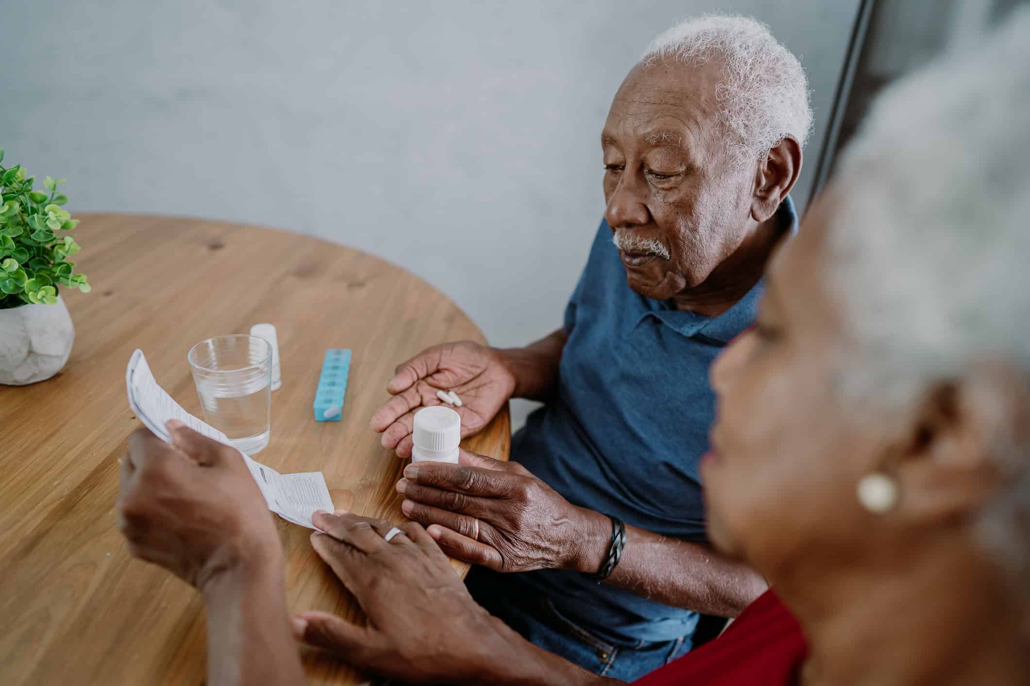 Senior couple taking medication at home